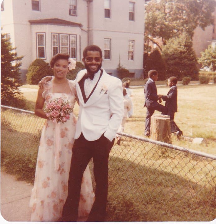 Jackie and Norman in wedding clothes outside